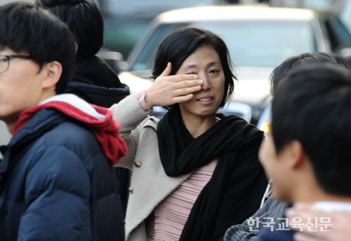 고생하셨습니다! 시험장으로 들어선 자녀의 모습을 보며 눈물을 흘리는 학부모 모습.
