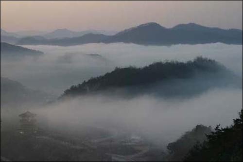 옥정호 주변을 에워싼 물안개로 인해 언덕이 섬처럼 보인다.